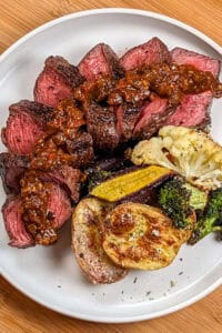 seared sliced steak dressed with baharat flavoring sauce with roasted vegetables tossed in parmesan herb seasoning.