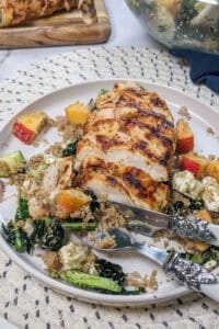 diamond grilled seared sliced chicken breast served with kale, diced peach and quinoa salad in spicy peach piri piri sauce.